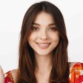 smiling-brunette-girl-waving-hand-say-hi-wearing-summer-floral-dress-standing-white-background-1-scaled-e1751000438976.jpg